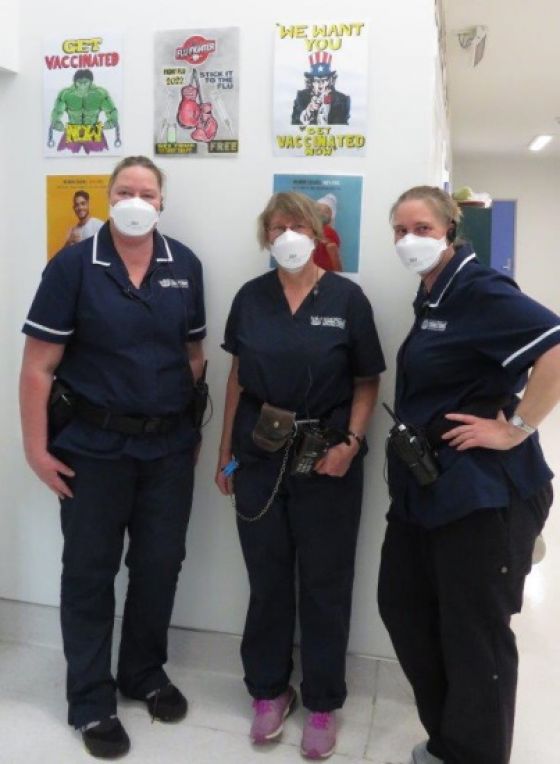 Nurses Christine McLean, Averill Glew and Alice Jamieson in front of the posters. 