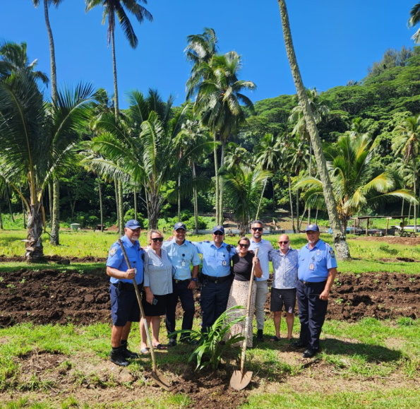 The team with the Ministry of Corrective Services prison staff after planting coconut trees