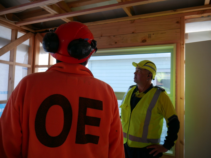 Alex and Lee discussing progress in one of the Kāinga Ora homes being built at the yard.