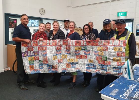 Community Work staff with their chip packet blanket.