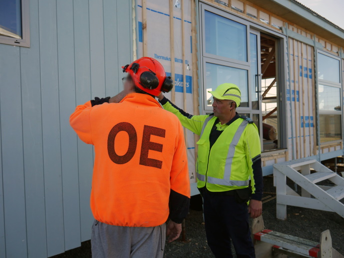 Alex, recently qualified as a Licensed Building Practitioner in prison, and Instructor Lee inspecting work at the yard.