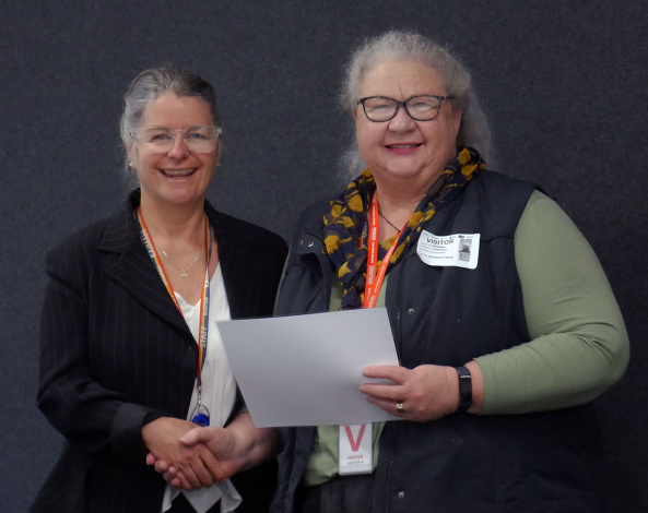 Polly Cunningham (left) presenting Case Manager Liz Matthews with her certificate.