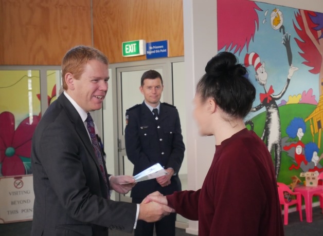 *Minister Hipkins congratulates a graduate (Corrections Southern Region Commissioner, Ben Clark in background)