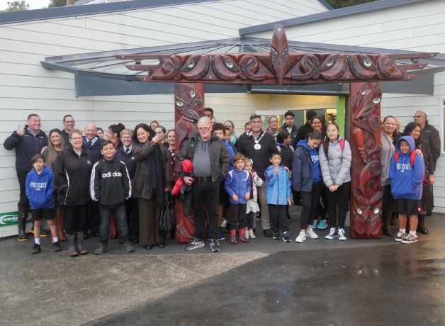 The Postgate School community gather under the waharoa after its unveiling.